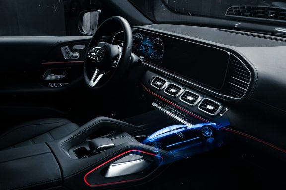 Modern car interior with a sleek dashboard, touchscreen, and ambient lighting.